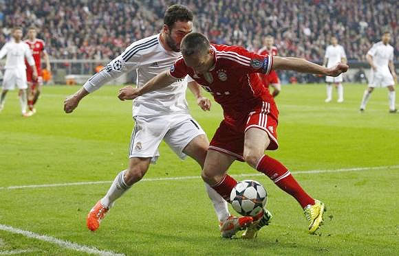 Bayern Munich's Franck Ribery (right) and Real Madrid's Daniel Carvajal fight for the ball during their Champions League semi-final second leg match in Munich on April 29