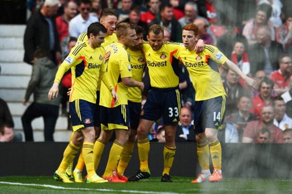 Sebastian Larsson (third from left) of Sunderland is congratulated by teammates after scoring against Manchester United