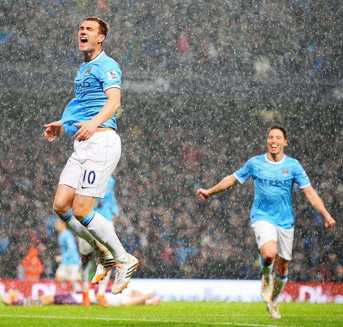 Edin Dzeko of Manchester City celebrates scoring the opening goal