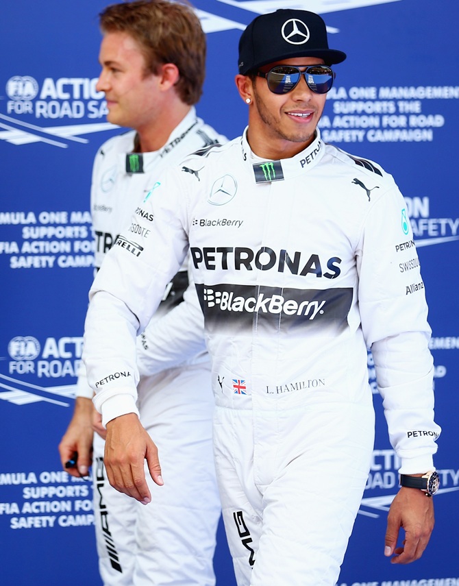 Lewis Hamilton of Great Britain and Mercedes GP celebrates with team-mate Nico   Rosberg of Germany and Mercedes 