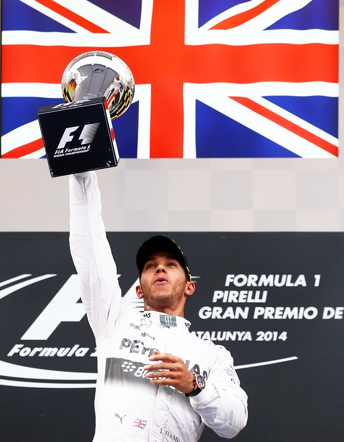 Race winner Lewis Hamilton of Great Britain and Mercedes GP lifts the trophy