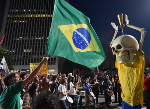 People take part in the 'International Day of World Cup Resistance' protest   against the upcoming FIFA World Cup Brazil 2014 along the streets of Sao Paulo