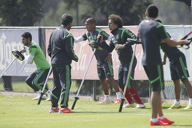 Mexico's Jesus Corona (left), Carlos Salcido (3rd from left) and Guillermo Ochoa (centre) exercise during a practice session in Mexico City on Wednesday
