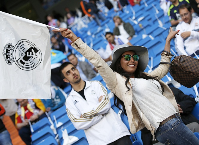 A Real Madrid fan waves her flag