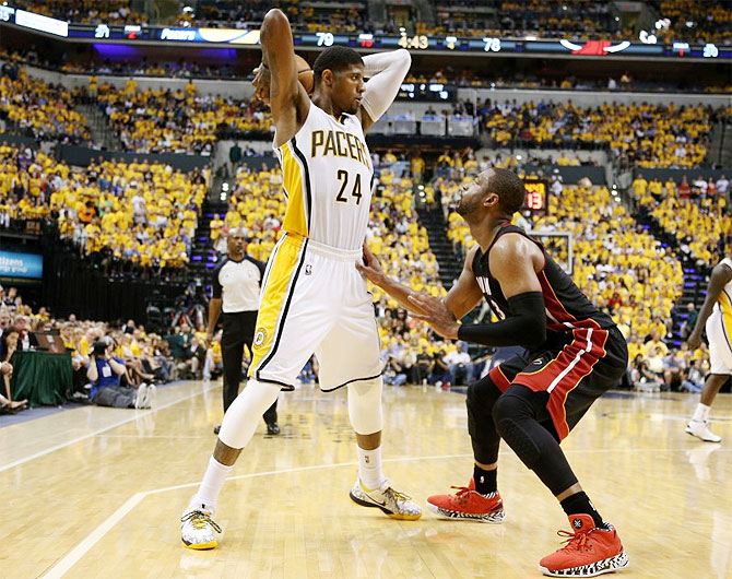 Indiana Pacers forward Paul George (24) works around the defense of Miami Heat guard Dwyane Wade (3) during the fourth quarter in game five of the Eastern Conference Finals of the 2014 NBA Playoffs at Bankers Life Fieldhouse on Wednesday