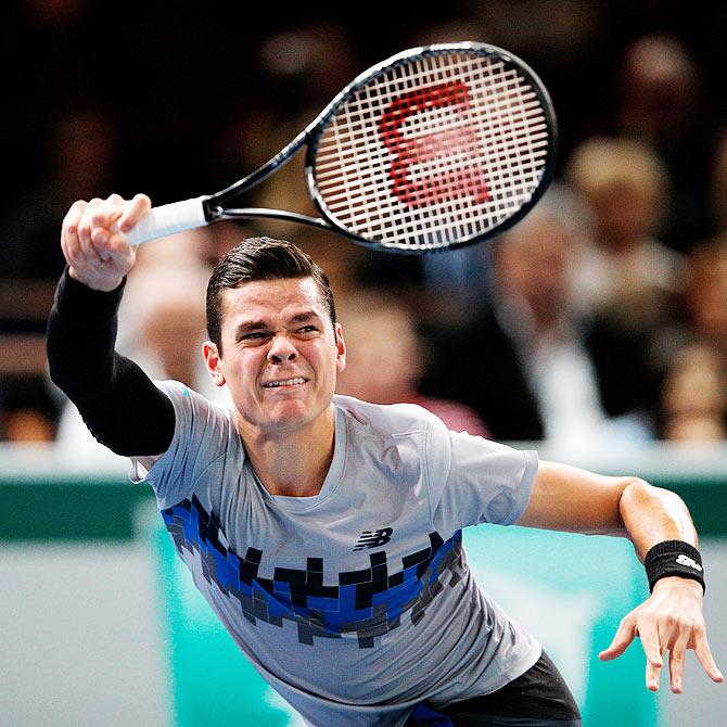 Milos Raonic of Canada in action against Novak Djokovic of Serbia 