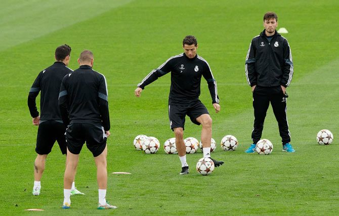 Cristiano Ronaldo (2nd from right) of Real Madrid CF trains with teammates James Rodriguez (left) and Karim Benzema (2nd from left) during the training session ahead of their UEFA Champions League Group B match against Liverpool FC at Valdebebas training ground in Madrid on Monday