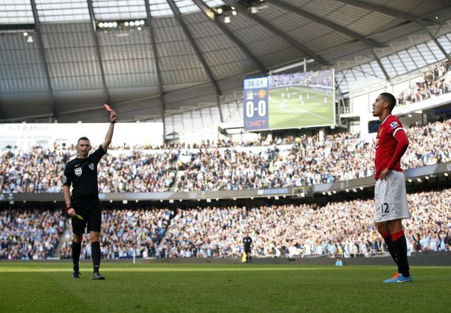 Referee Michael Oliver shows the red card to Manchester United's Chris Smalling during their English Premier League match against Manchester City at the Etihad Stadium on Sunday