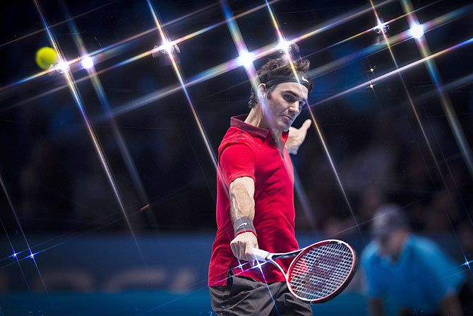 Roger Federer of Switzerland in action against Milos Raonic of Canada during their round robin tie at the ATP World Tour Finals at O2 Arena in London on Sunday