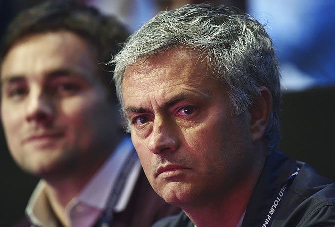 Jose Mourinho, (R) manager of Chelsea football club, watches the match between Andy Murray and Roger Federer on Thursday