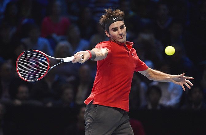 Roger Federer of Switzerland returns the ball against Andy Murray during their ATP World Tour finals match at the O2 Arena in London on Thursday