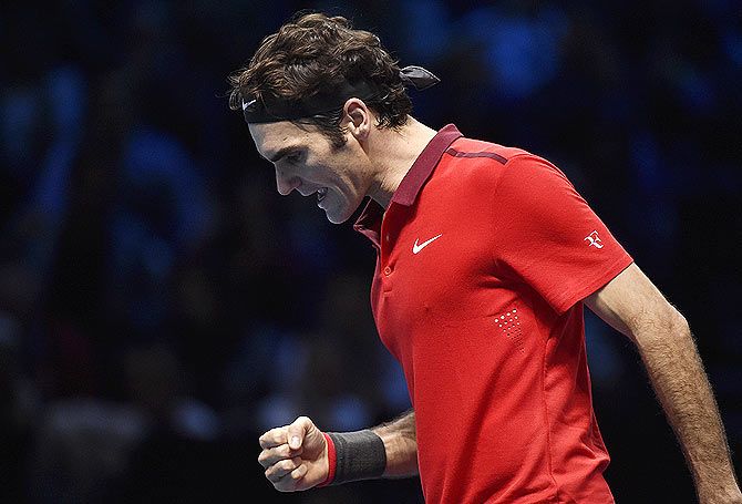 Roger Federer reacts during his match against compatriot Stanislas Wawrinka during the ATP Tour Finals on Saturday