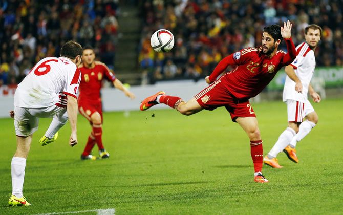   Spain's Isco (2nd from right) wins the ball against Belarus' Sergei Balanovich (left) during their Euro 2016 Group C qualifying match in Huelva on Saturday