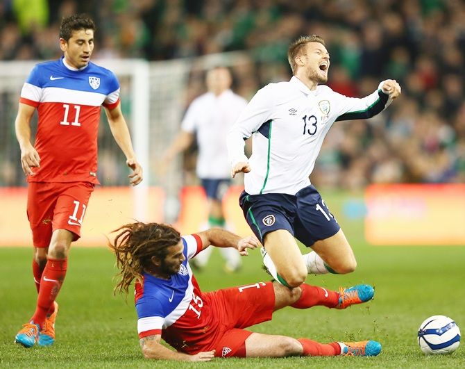 Anthony Pilkington, right, of Ireland is fouled by Kyle Beckerman of USA