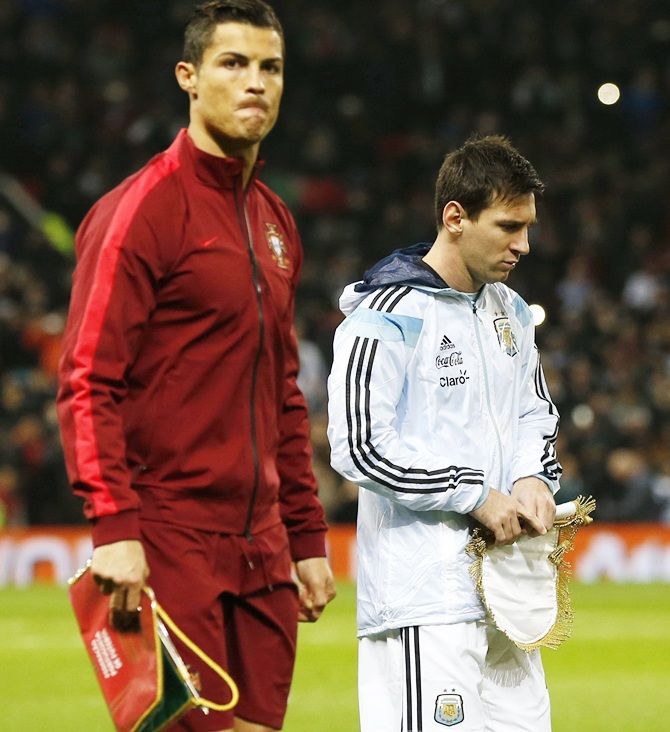 Argentina's Lionel Messi, right, and Portugal's Cristiano   Ronaldo walk round the pitch 