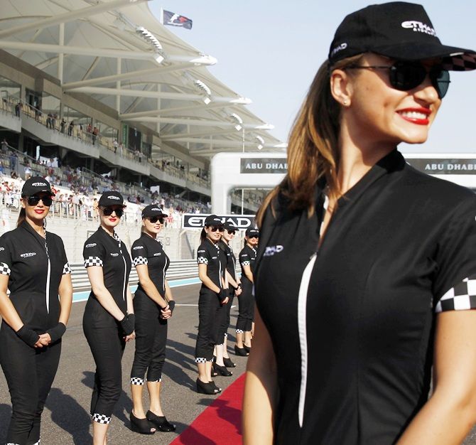 Grid girls pose before the Abu Dhabi F1 Grand Prix at the Yas Marina circuit