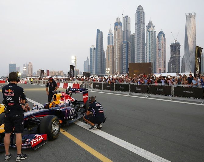 The Infiniti Red Bull Racing RB7 is pushed back into the garage during an Infiniti Red Bull   Racing show run ahead of the Abu Dhabi Formula One Grand Prix at Yas Marina Circuit