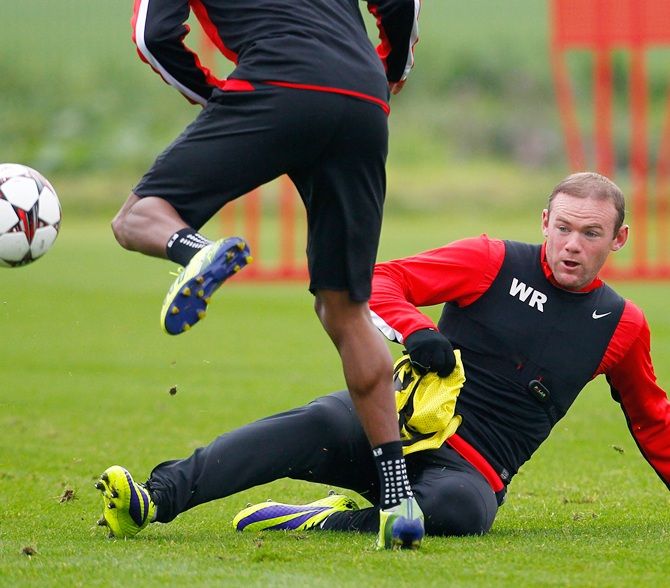 Wayne Rooney, right, of Manchester United in action during a training session