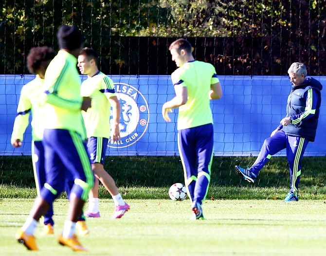 Chelsea manager Jose Mourinho kicks a ball during a training session