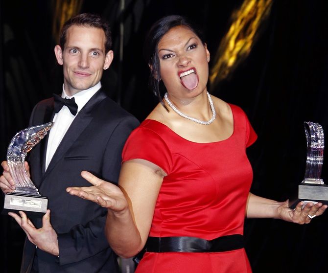 Valerie Adams of New Zealand, right, reacts as she poses with World-record pole vaulter Renaud Lavillenie of France