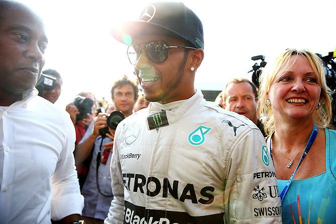Lewis Hamilton of Great Britain and Mercedes GP with his father Anthony and his stepmother Linda