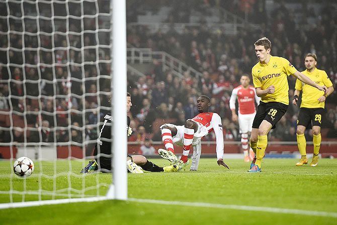 Arsenal's Yaya Sanogo (centre) scores a goal against Borussia Dortmund during their Champions League group D soccer match in London on Wednesday