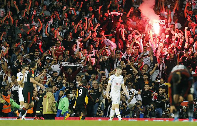  Besiktas' Demba Ba (centre) celebrates in front of supporters after scoring a penalty shot during their Europa League Group C soccer match against Tottenham Hotspur at White Hart Lane on Thursday