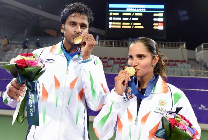 Sania Mirza (right) and Saketh Myneni pose with their gold medals.