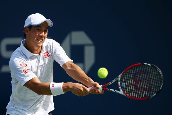 Kei Nishikori of Japan returns a shot against Novak Djokovic of Serbia during their men's singles semi-final match