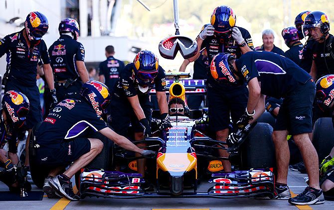 Members of the Infiniti Red Bull Racing team take part in a pit stop practice session during previews ahead of the Russian Formula One Grand Prix at Sochi Autodrom