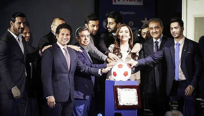 Club owners and representatives of sponsors and organisers take a pledge over a soccer ball replica during the emblem-unveiling ceremony of Indian Super League in Mumbai