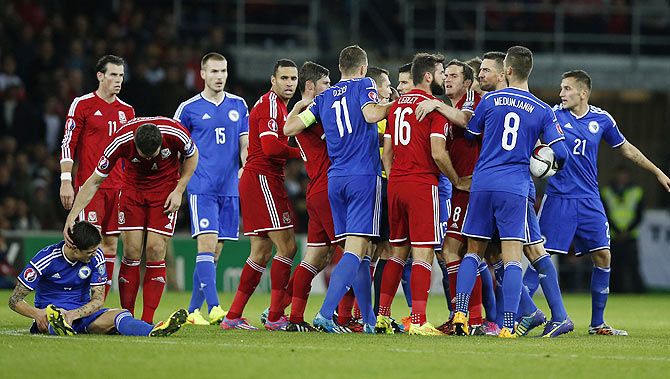 Wales and Bosnia and Herzegovina players confront each other after a strong challenge involving Bosnia and Herzegovina's Muhamed Besic (left) during their Euro 2016 Group B qualifying match at Cardiff City Stadium on Friday.