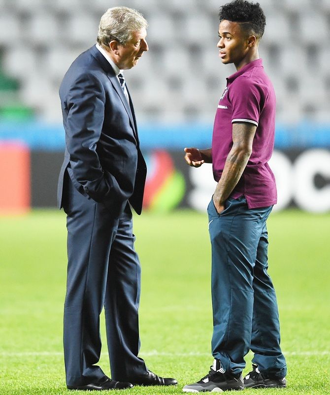 Manager Roy Hodgson of England talks to Raheem Sterling