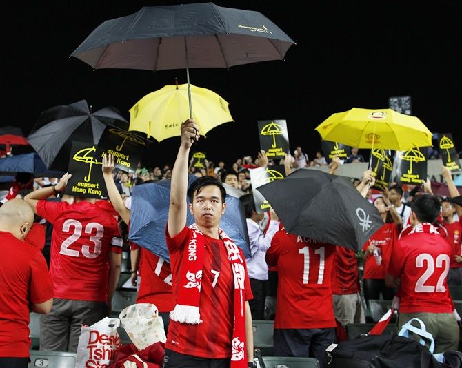 Occupy Central supporters hold up umbrellas