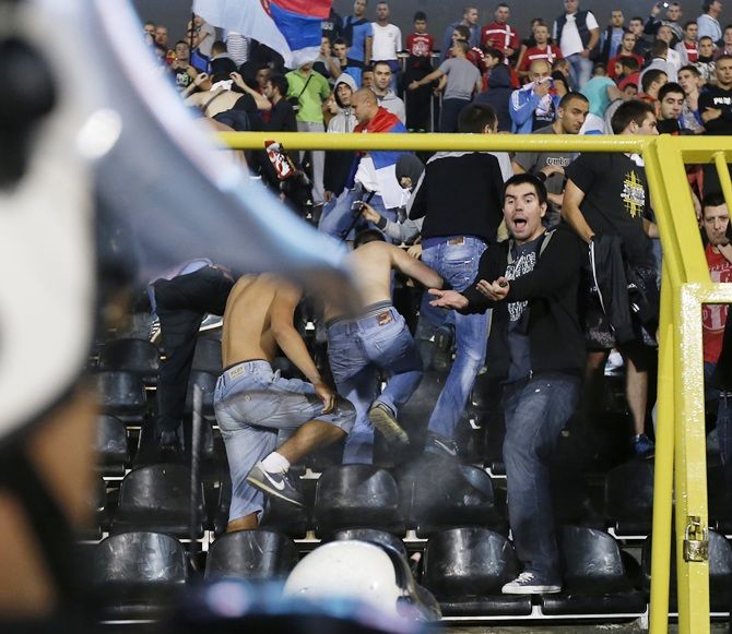Fans of Serbia confront the riot police