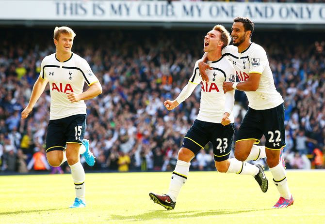 Christian Eriksen of Spurs celebrates with team-mates Nacer Chadli and Eric Dier