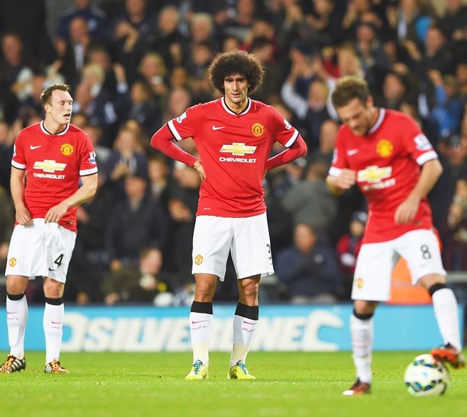 From left, Phil Jones, Marouane Fellaini and Juan Mata of Manchester United