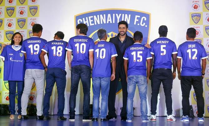 Co-owners Abhishek Bachchan (centre) and Vita Dani (extreme left) with Chennaiyin FC players at the launch of the team jersey in Mumbai