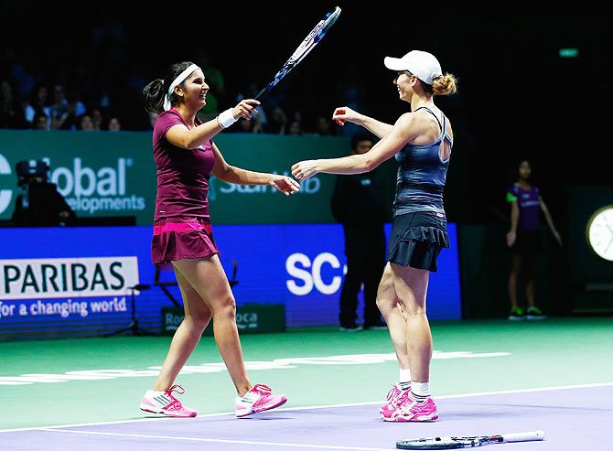 Cara Black of Zimbabwe and Sania Mirza of India celebrate defeating Raquel USA's Kops-Jones and Abigail Spears in the doubles quarter-finals at the WTA Finals on Thursday