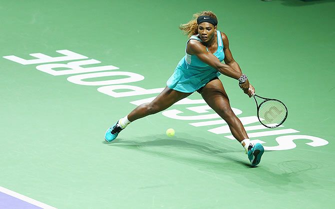 Serena Williams of the United States stretches to play a backhand against Eugenie Bouchard of Canada