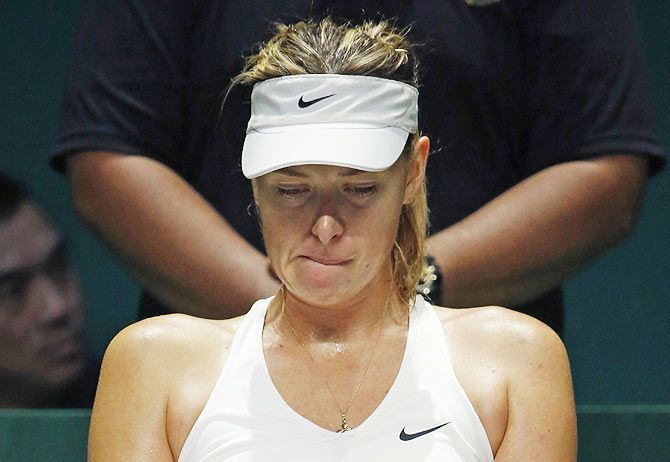 Maria Sharapova of Russia rests in between games in the second set against Petra Kvitova of the Czech Republic during their WTA Finals match at the Singapore Indoor Stadium on Thursday