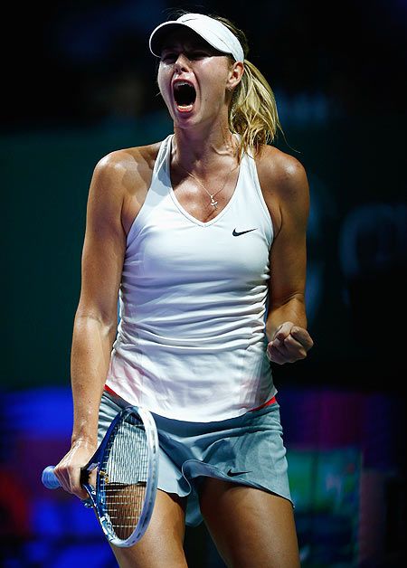 Maria Sharapova of Russia celebrates winning a game in her match against Agnieszka Radwanska of Poland during the WTA Finals at the Singapore Sports Hub on Friday