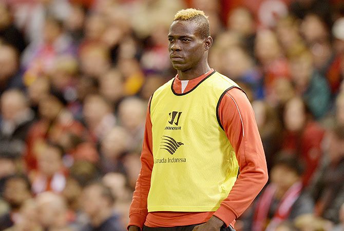 Mario Balotelli of Liverpool watches from the sidelines during the Capital One Cup Fourth Round match between Liverpool and Swansea City at Anfield on Tuesday