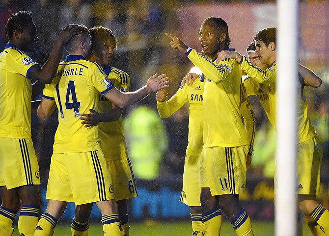 Didier Drogba of Chelsea celebrates scoring the opening goal against Shrewsbury Town during the Capital One Cup Fourth Round match between and Chelsea at Greenhous Meadow on Tuesday