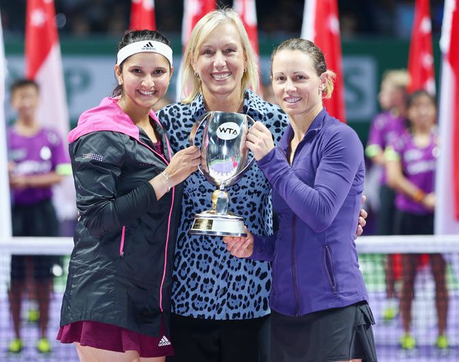 Sania Mirza of India and Cara Black of Zimbabwe pose for a photograph with Martina Navratilova after their straight sets victory at the WTA Finals at Singapore Sports Hub on Sunday