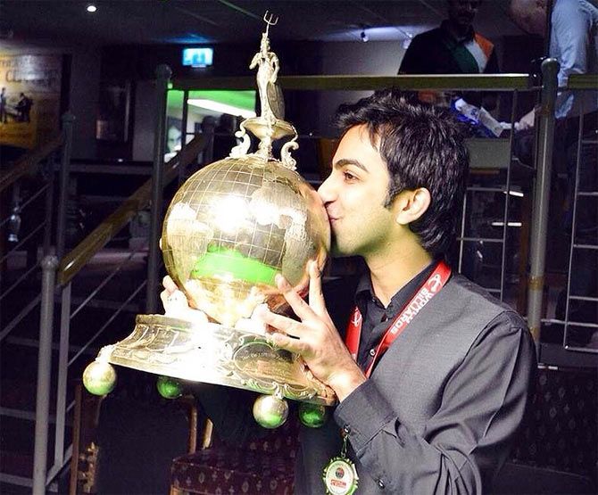 Pankaj Advani celebrates with the World Billiards Championships trophy on Wednesday
