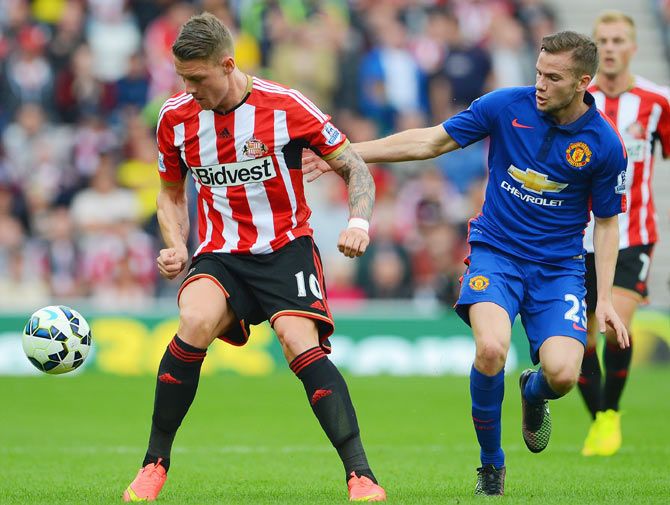 Connor Wickham of Sunderland is closed down by Tom Cleverley of Manchester United during their Barclays Premier League match