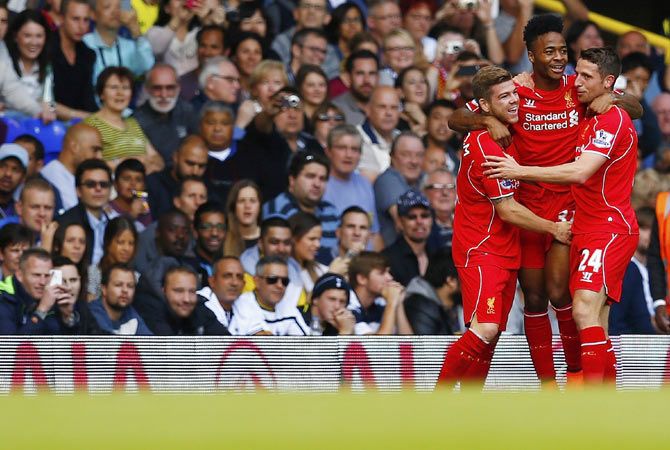 Liverpool's Raheem Sterling (centre) celebrates with teammates Alberto Moreno (left) and Joe Allen after scoring the opening goal during their English Premier League soccer match against Tottenham Hotspur at White Hart Lane
