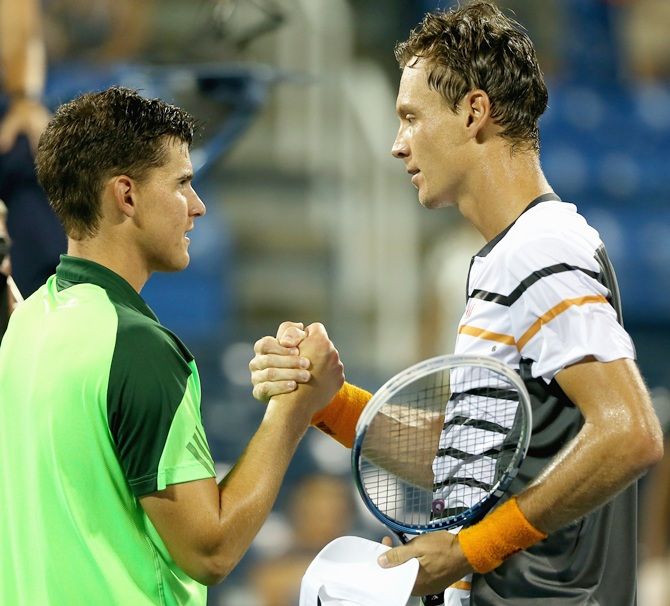 Tomas Berdych, right, of the Czech Republic shakes hands with Dominic Thiem of Austria