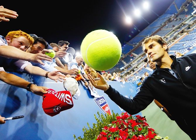 Roger Federer of Switzerland signs autographs for fans